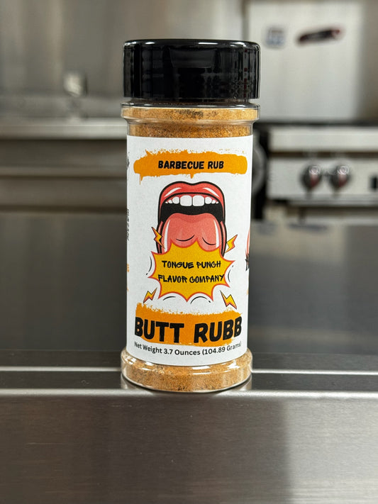 Jar of barbecue rub labeled 'Butt Rub' on a kitchen counter.